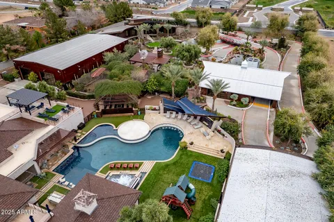 a view of house with swimming pool and furniture