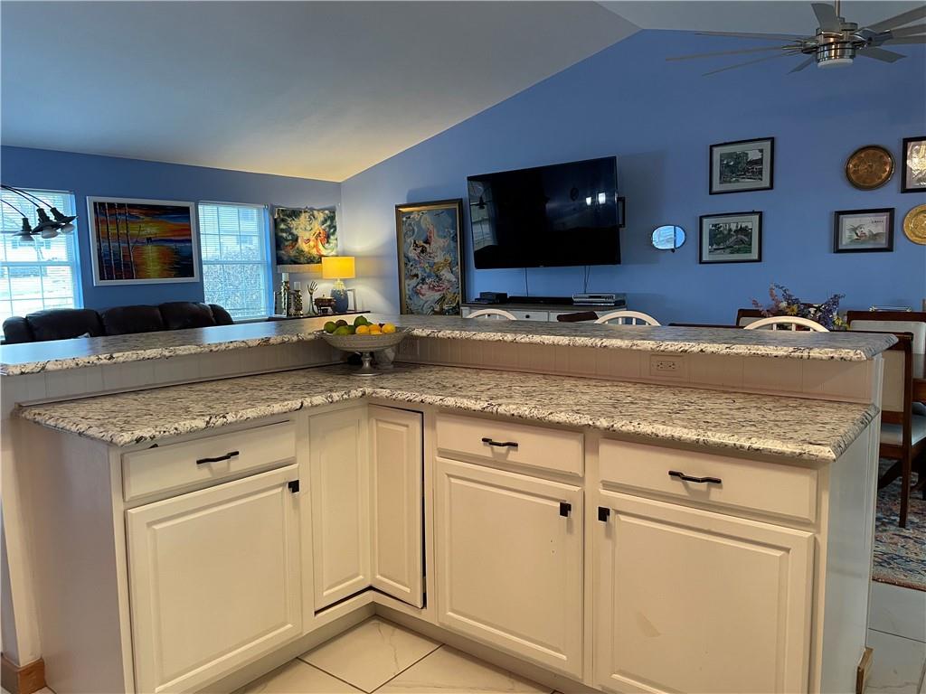 601 Slippery Rock Road Slippery Rock, PA 16057 - Photo 14 of 25 a kitchen with granite countertop a stove and a flat screen tv