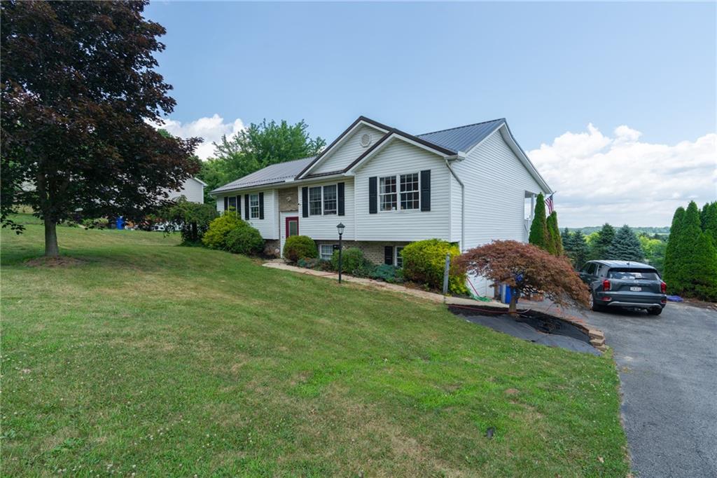 601 Slippery Rock Road Slippery Rock, PA 16057 - Photo 3 of 25 a view of a house with a big yard and large trees
