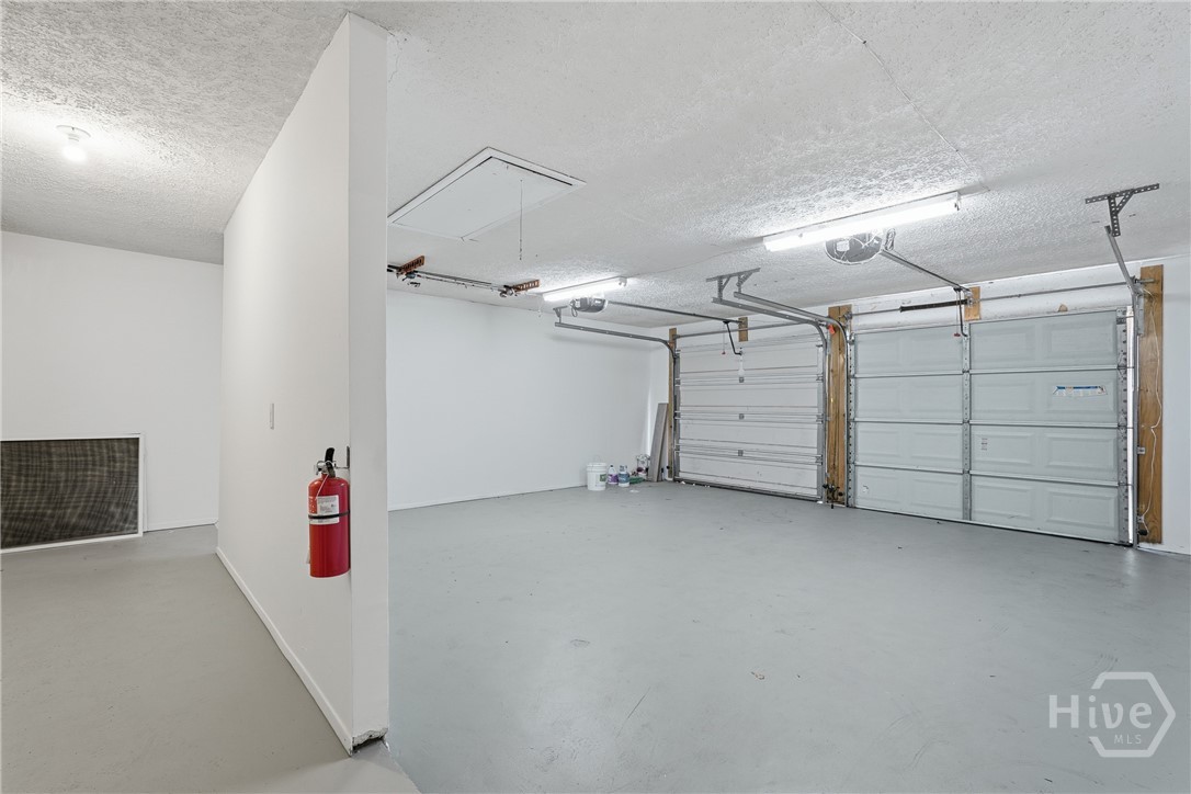 17 Cuttysark Road Savannah, GA 31410 - Photo 25 of 31 Newly painted garage with painted floors, separate storage area and back door access to rear