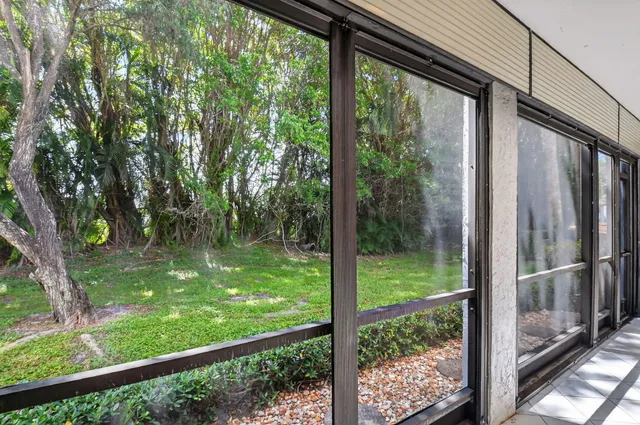 a living room with furniture a rug and a book shelf