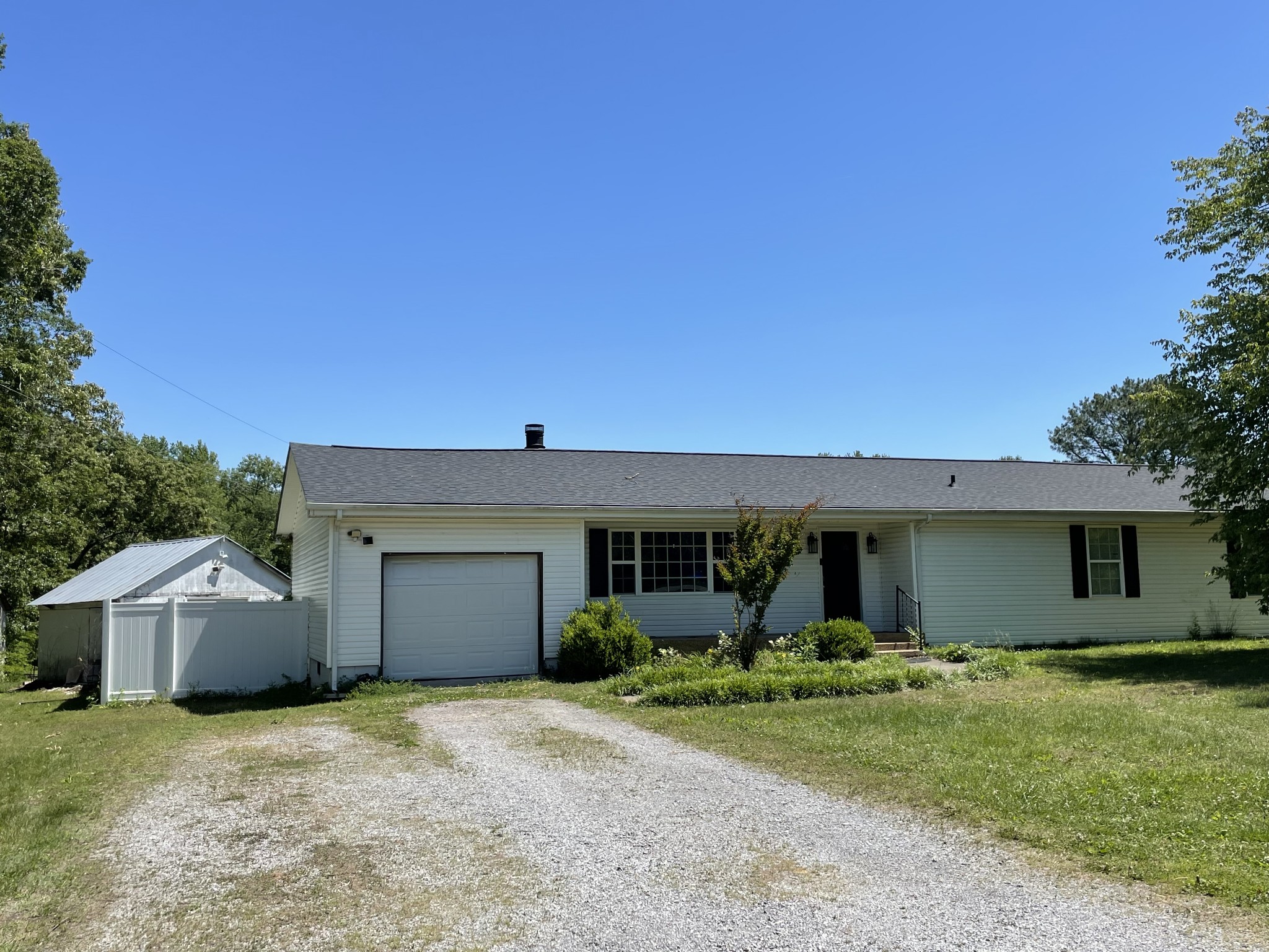 305 Cedar Hill Road Adams, TN 37010 - Photo 1 of 34 a front view of a house with garden