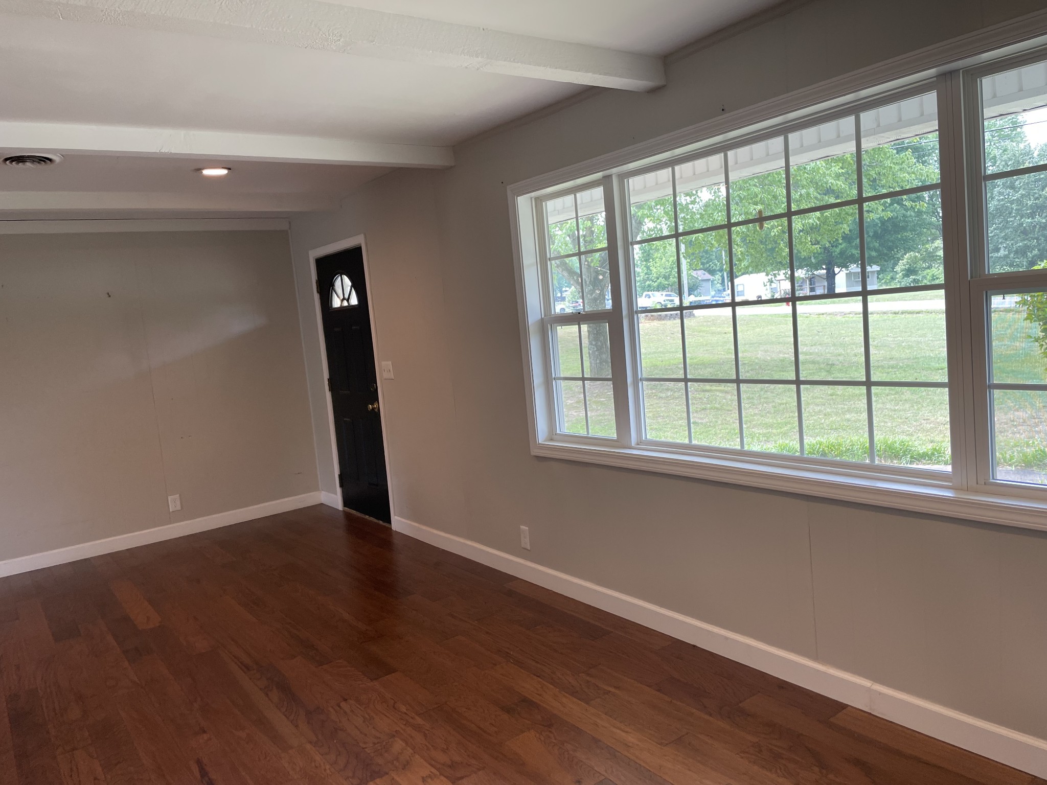 305 Cedar Hill Road Adams, TN 37010 - Photo 12 of 34 a view of an empty room with wooden floor and a window