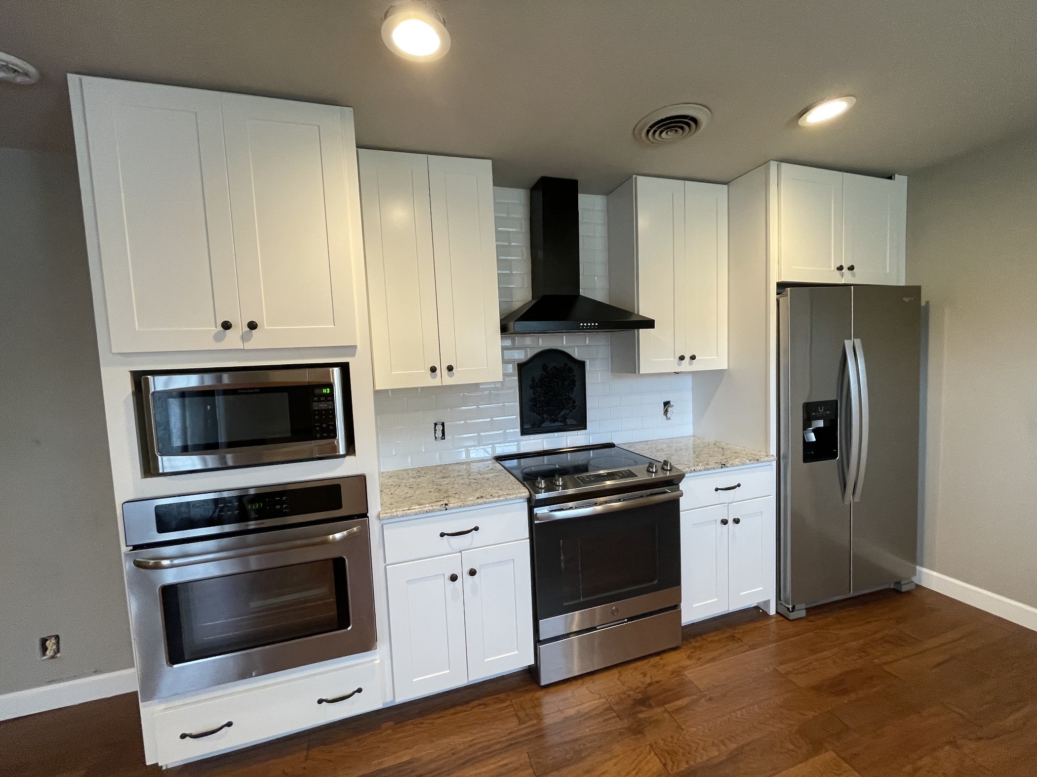 305 Cedar Hill Road Adams, TN 37010 - Photo 15 of 34 a kitchen with granite countertop a stove and a refrigerator