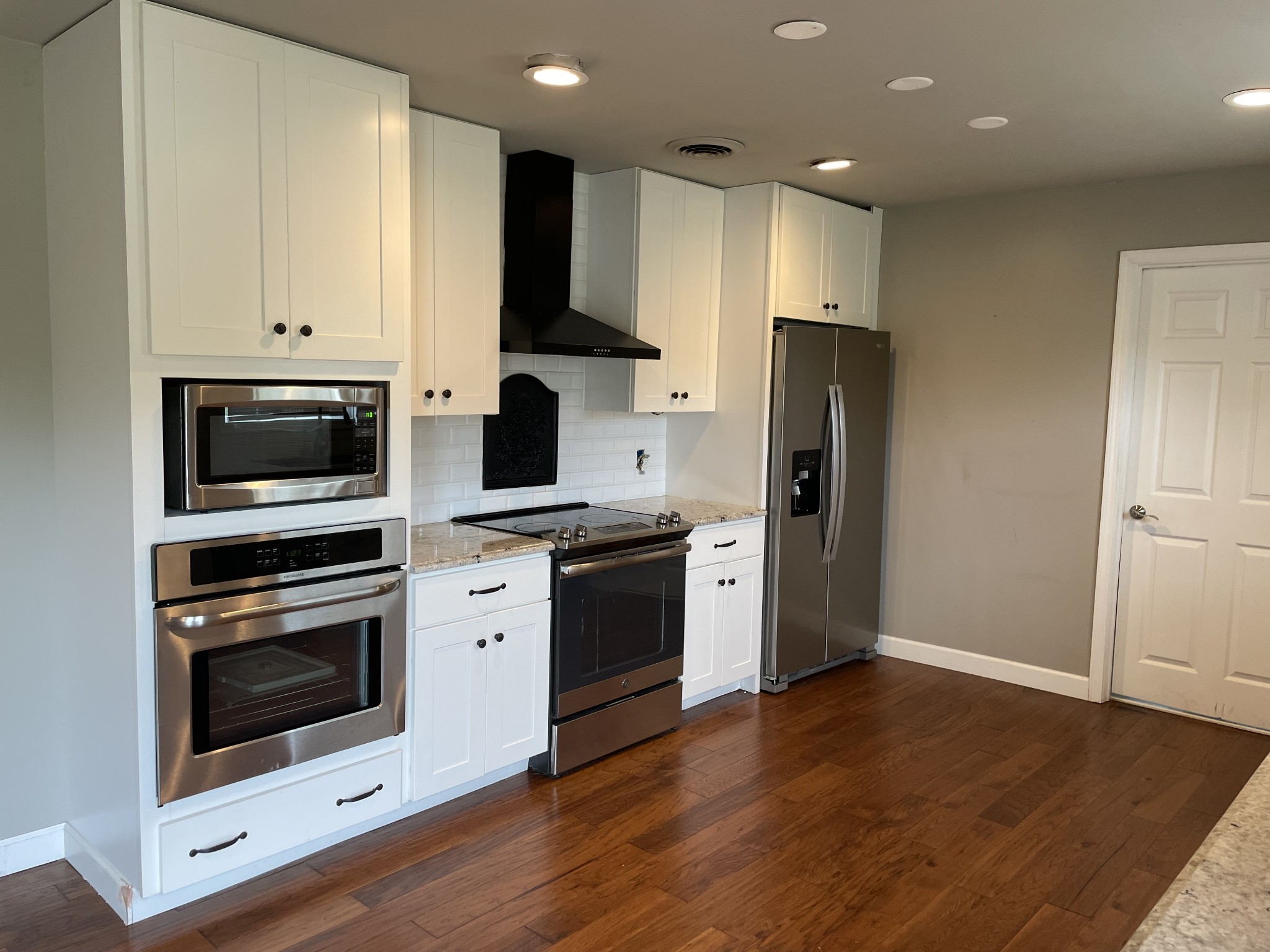 305 Cedar Hill Road Adams, TN 37010 - Photo 17 of 34 a kitchen with cabinets stainless steel appliances and wooden floor