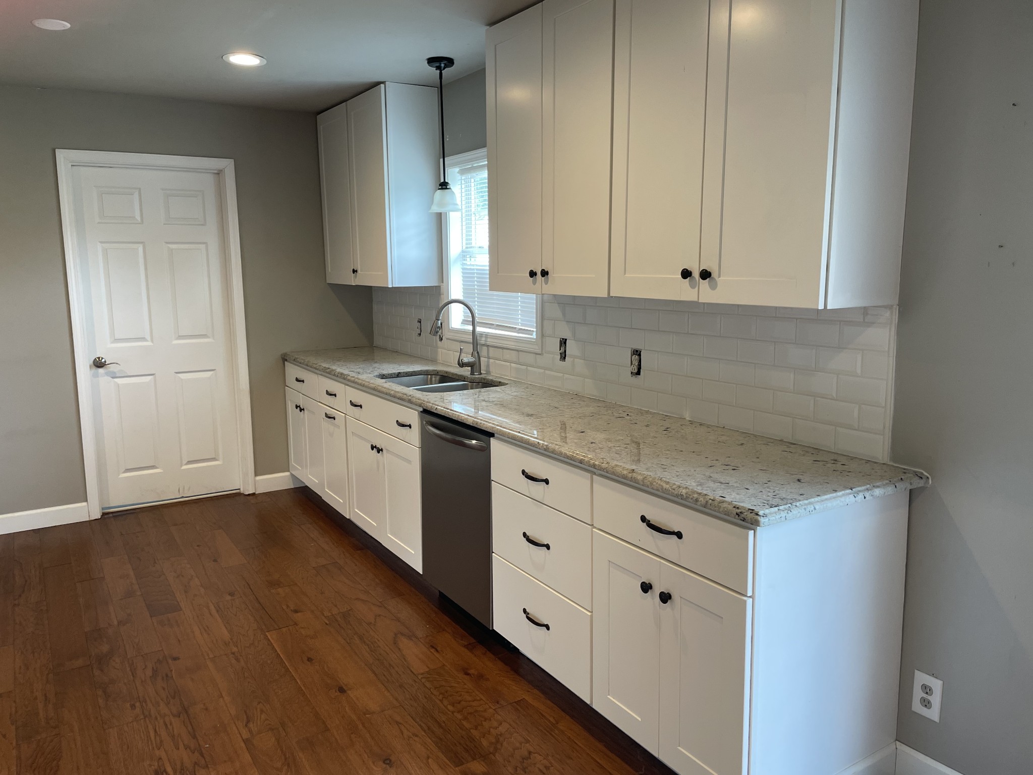 305 Cedar Hill Road Adams, TN 37010 - Photo 19 of 34 a kitchen with granite countertop a sink a stove and cabinets