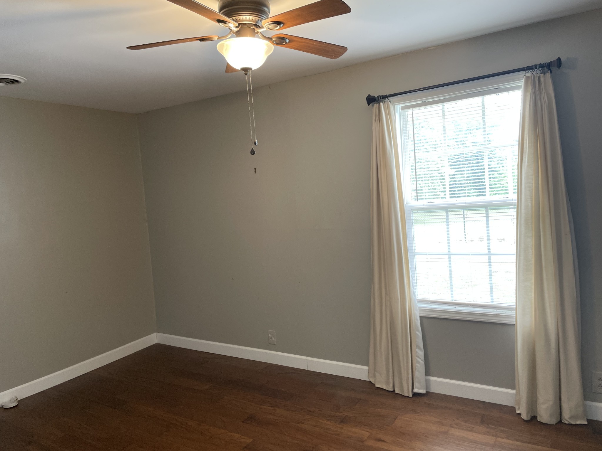 305 Cedar Hill Road Adams, TN 37010 - Photo 30 of 34 an empty room with wooden floor windows and fan