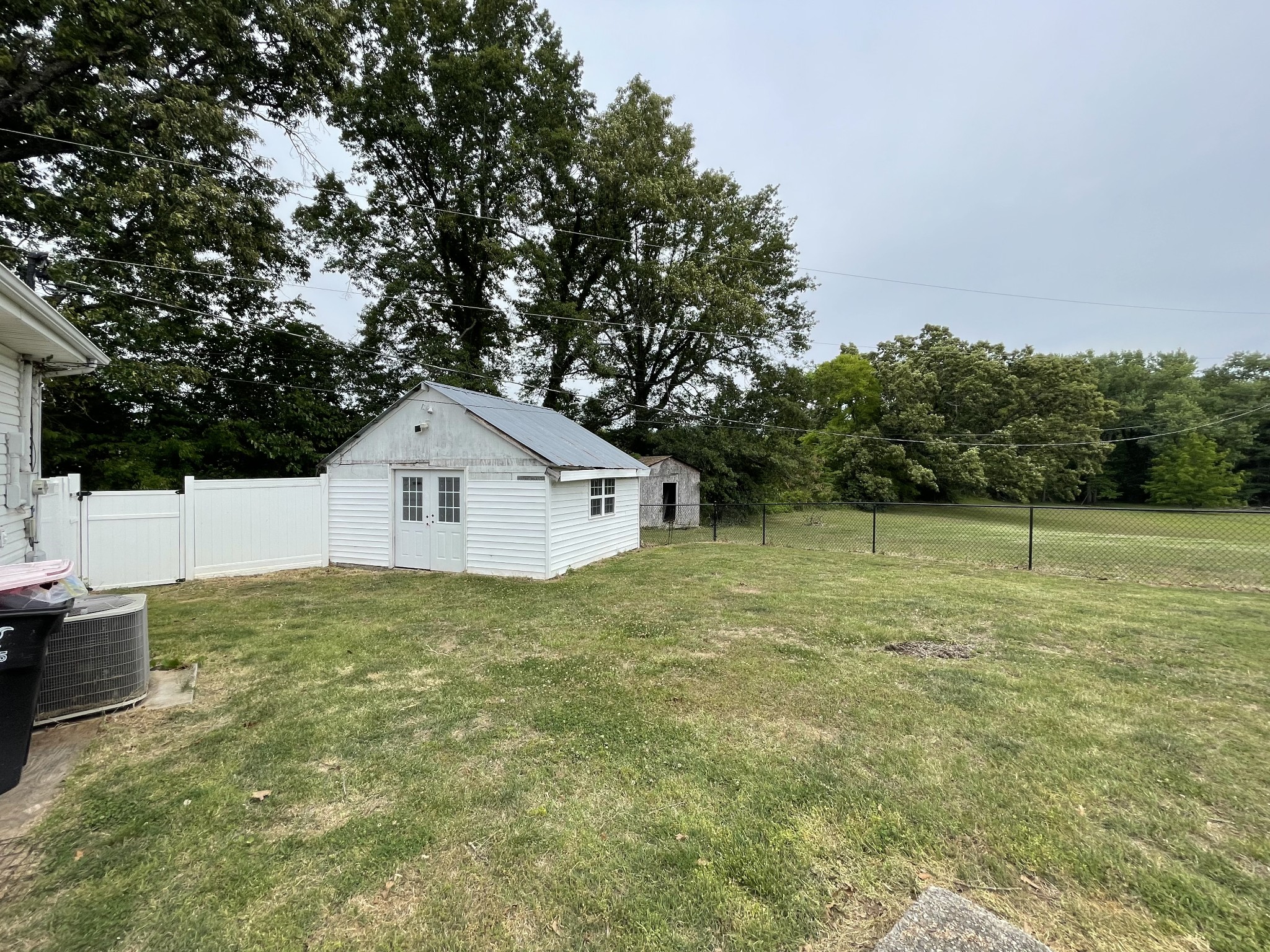 305 Cedar Hill Road Adams, TN 37010 - Photo 9 of 34 a house with green field