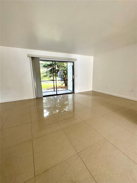 13300 Walsingham Road, Unit 61 Largo, FL 33774 - Photo 4 of 18 an empty room with windows