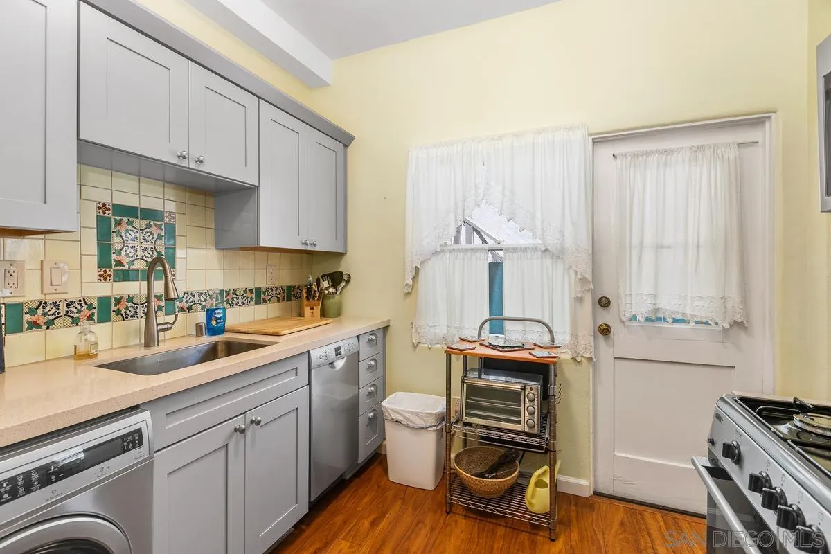 751 G Avenue Coronado, CA 92118 - Photo 12 of 23 a kitchen with a sink cabinets and wooden floor