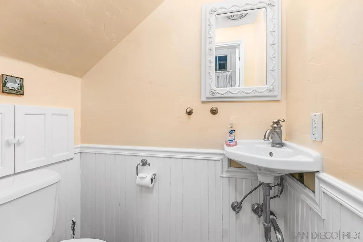 751 G Avenue Coronado, CA 92118 - Photo 13 of 23 a bathroom with a sink a mirror and a shower
