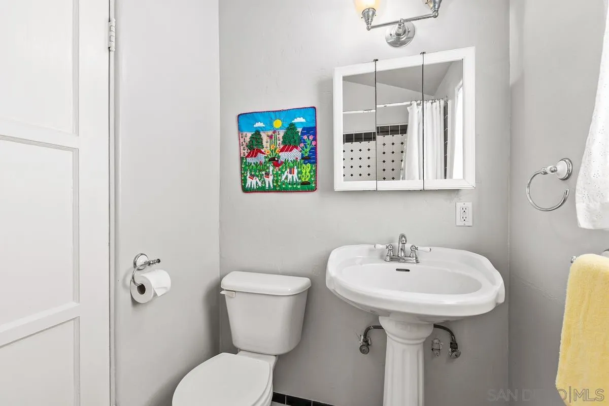 751 G Avenue Coronado, CA 92118 - Photo 18 of 23 a bathroom with a sink and mirror with toilet