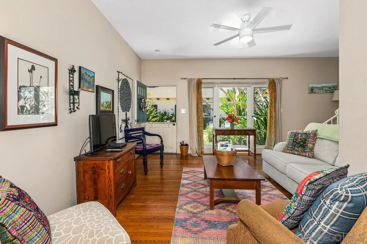 751 G Avenue Coronado, CA 92118 - Photo 6 of 23 a living room with furniture a flat screen tv and a floor to ceiling window