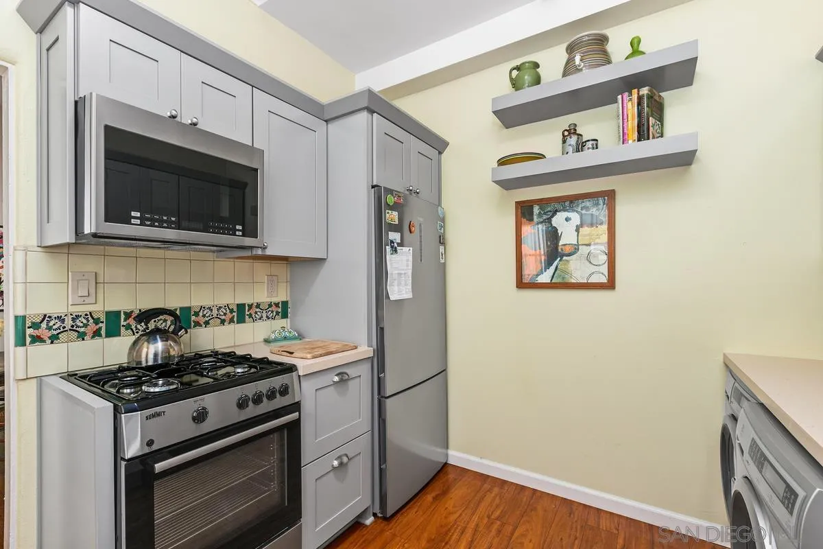 751 G Avenue Coronado, CA 92118 - Photo 10 of 23 a kitchen with stainless steel appliances a stove and a microwave