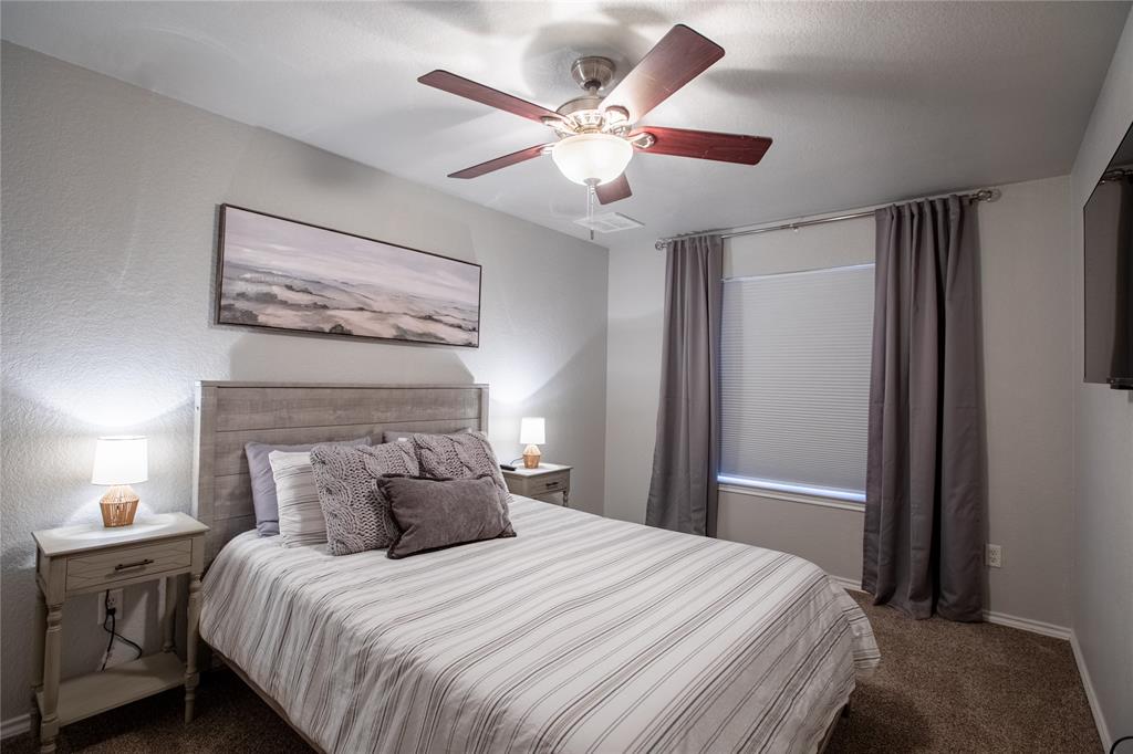 2702 River Ridge Court Granbury, TX 76048 - Photo 12 of 21 Bedroom featuring dark colored carpet and a ceiling fan