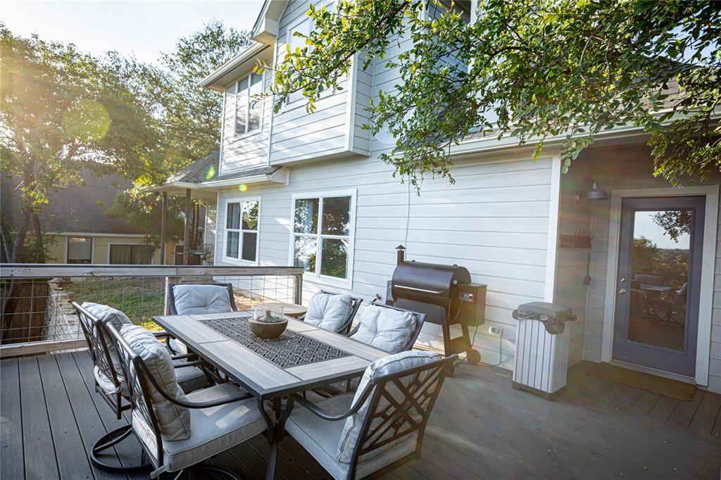 2702 River Ridge Court Granbury, TX 76048 - Photo 15 of 21 Wooden deck featuring a grill and outdoor dining area