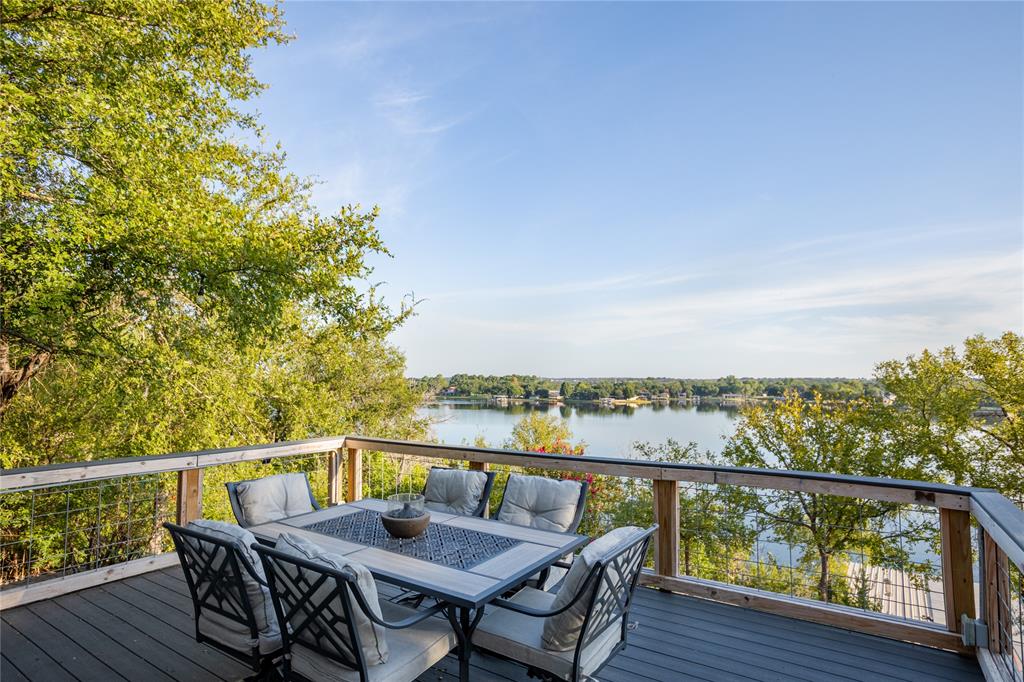 2702 River Ridge Court Granbury, TX 76048 - Photo 3 of 21 Deck with outdoor dining space and a water view