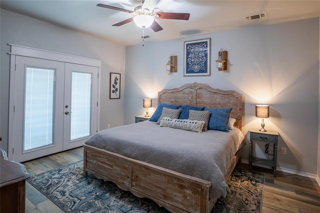 2702 River Ridge Court Granbury, TX 76048 - Photo 10 of 21 Bedroom with access to exterior, french doors, wood finished floors, and ceiling fan