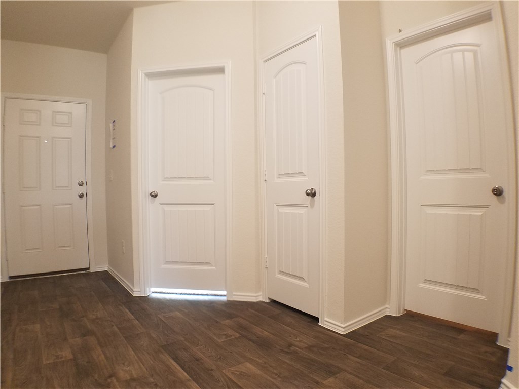 15016 Harkness Pass Austin, TX 78725 - Photo 4 of 25 an empty room with wooden floor
