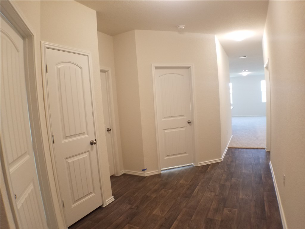 15016 Harkness Pass Austin, TX 78725 - Photo 5 of 25 a view of a hallway with wooden floor