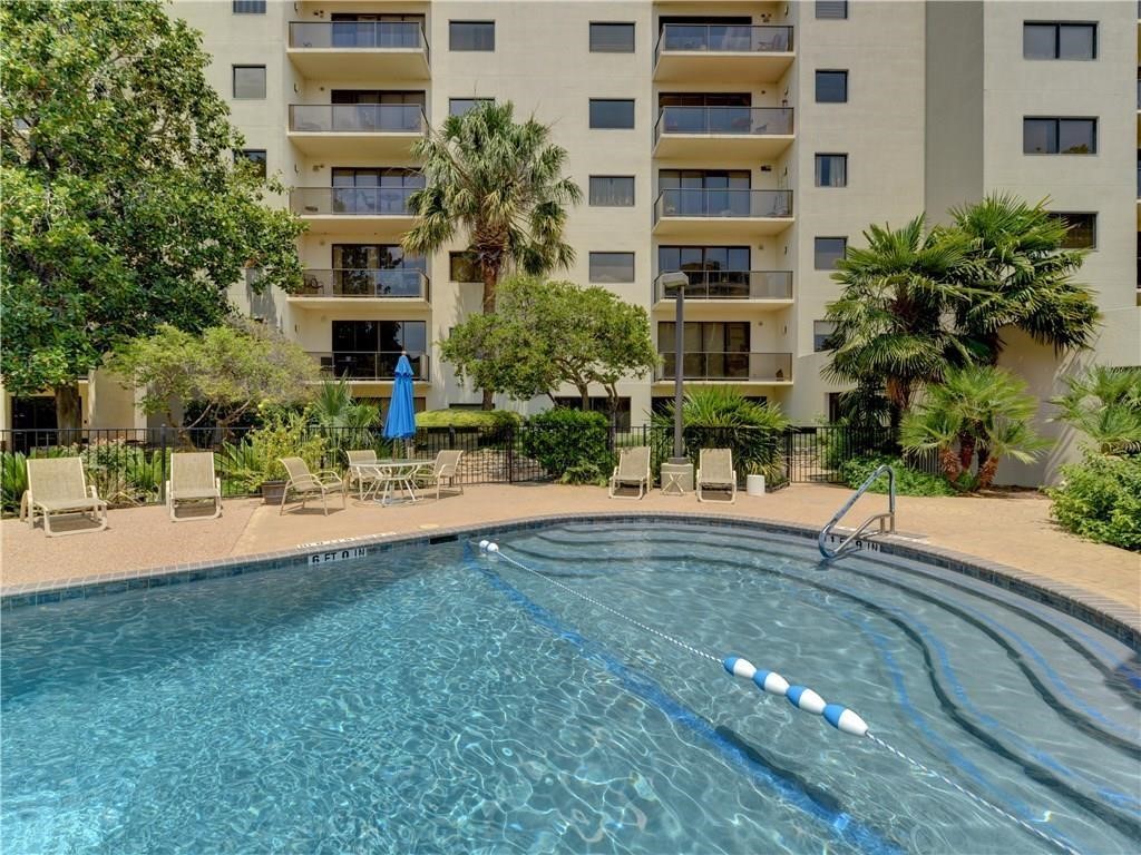 a front view of a multi story building with yard