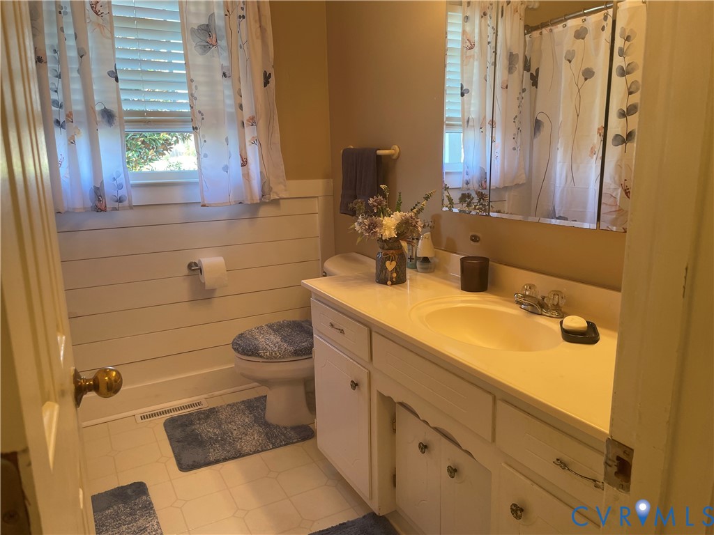 8002 Vaughan Road Petersburg, VA 23805 - Photo 18 of 31 a bathroom with a sink and mirror with toilet