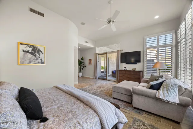 a bedroom with furniture and a flat screen tv