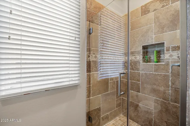 a bathroom with a shower and a window