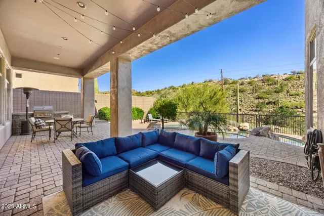 a outdoor living space with furniture and a flat screen tv