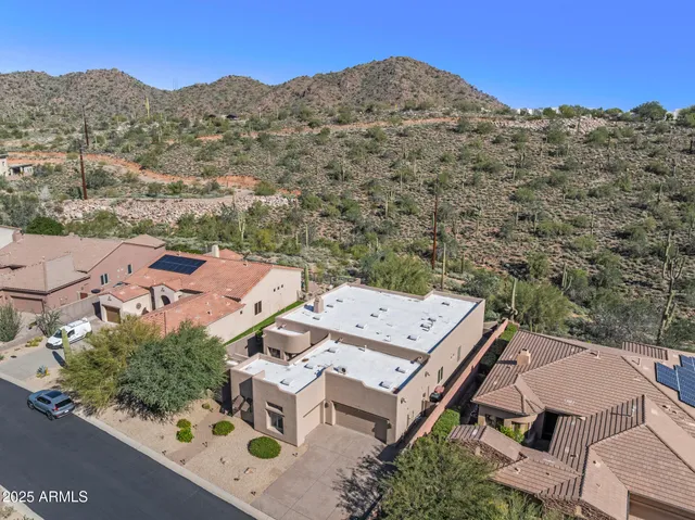 an aerial view of a house with a mountain view
