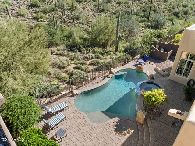 an aerial view of a houses with a mountain