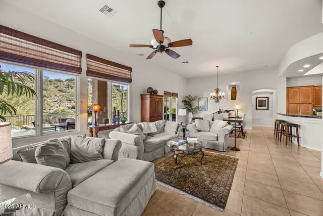a living room with lots of furniture and a chandelier