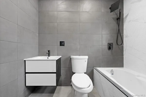 a white toilet sitting next to a bathroom sink