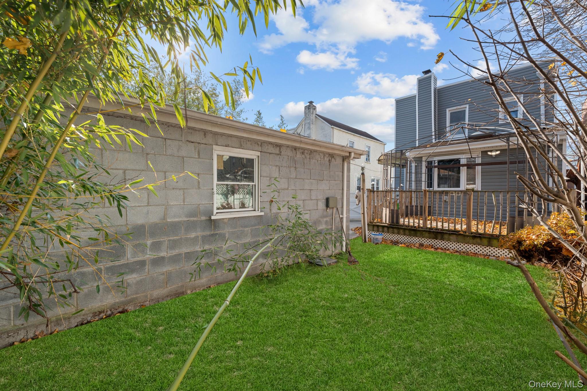 115-39 202nd Street Queens, NY 11412 - Photo 27 of 29 View of green lawn with a deck