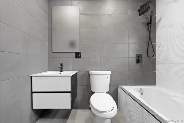 a white toilet sitting next to a bathroom sink