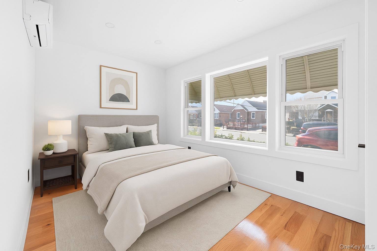 115-39 202nd Street Queens, NY 11412 - Photo 8 of 29 Bedroom with an AC wall unit and light wood-style flooring