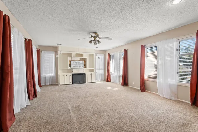 a view of a livingroom with a fireplace and window