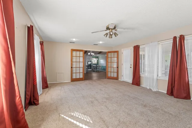 a view of a room with furniture and a ceiling fan