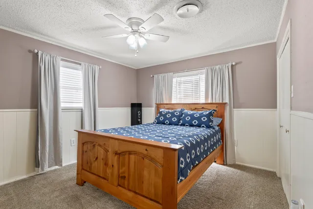 a bedroom with a bed and a chandelier