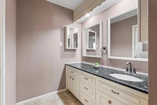 a bathroom with double sink and a mirror