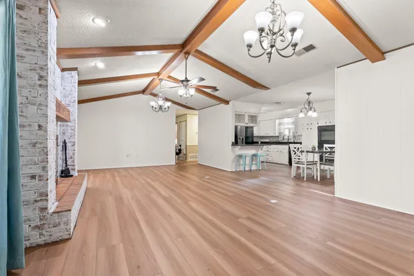 a view of a livingroom with furniture and a kitchen