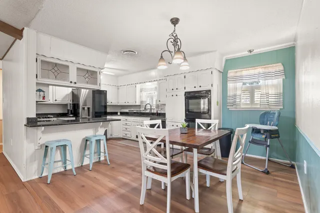 a view of a dining room with furniture window and wooden floor