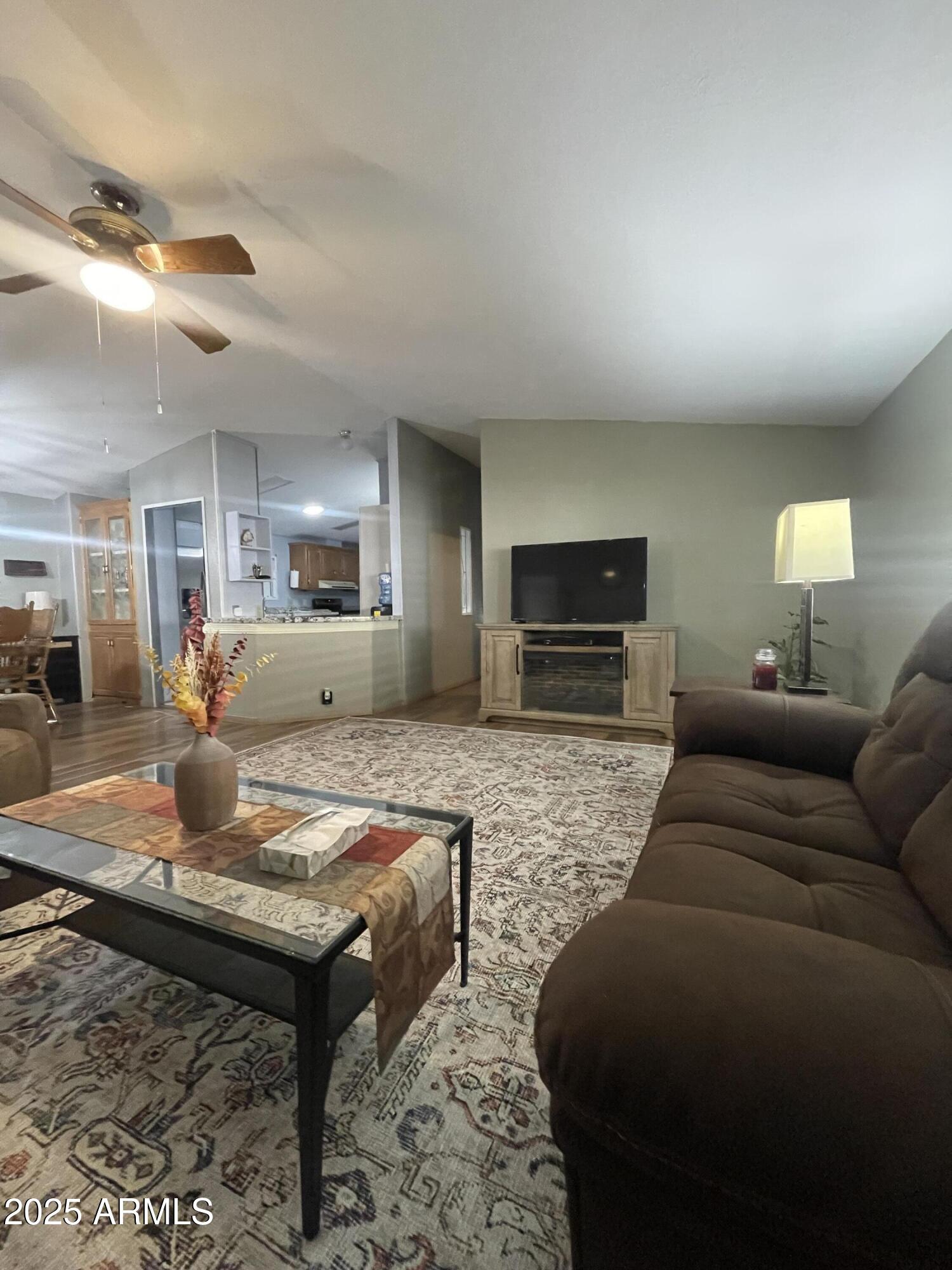 2100 North Trekell Road, Unit 254 Casa Grande, AZ 85122 - Photo 3 of 27 a living room with furniture and a flat screen tv