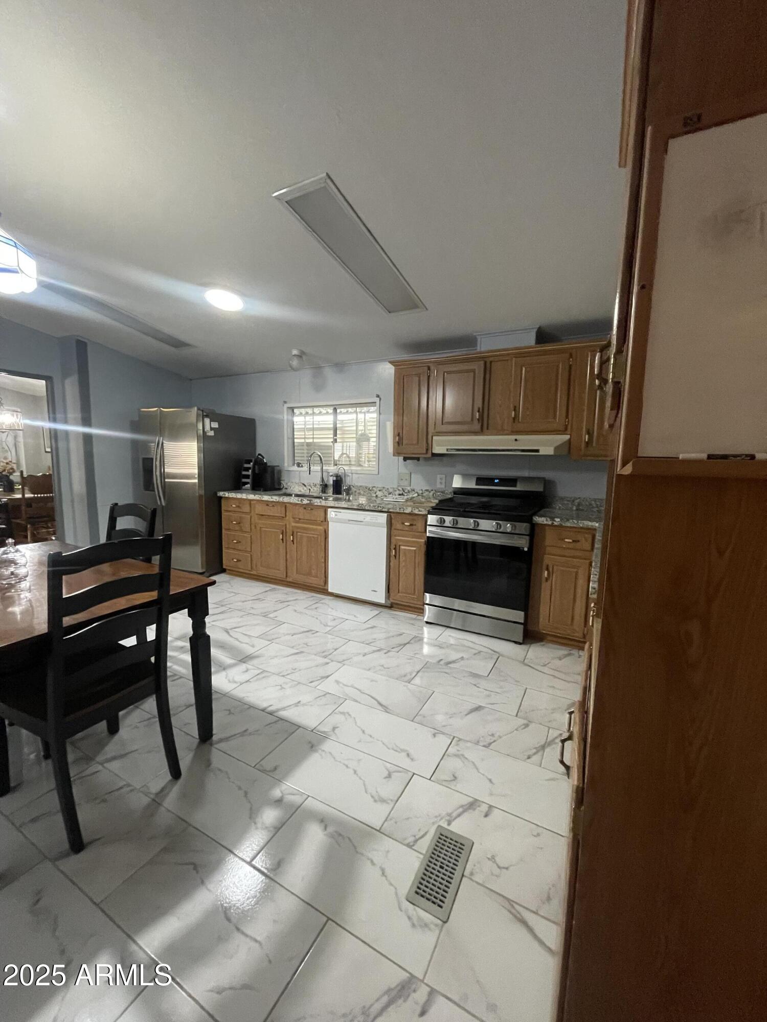 2100 North Trekell Road, Unit 254 Casa Grande, AZ 85122 - Photo 7 of 27 a kitchen with stainless steel appliances a stove a sink a counter top space and cabinets