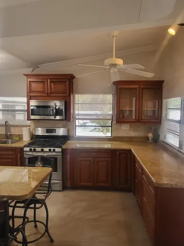 a living room with furniture and a ceiling fan