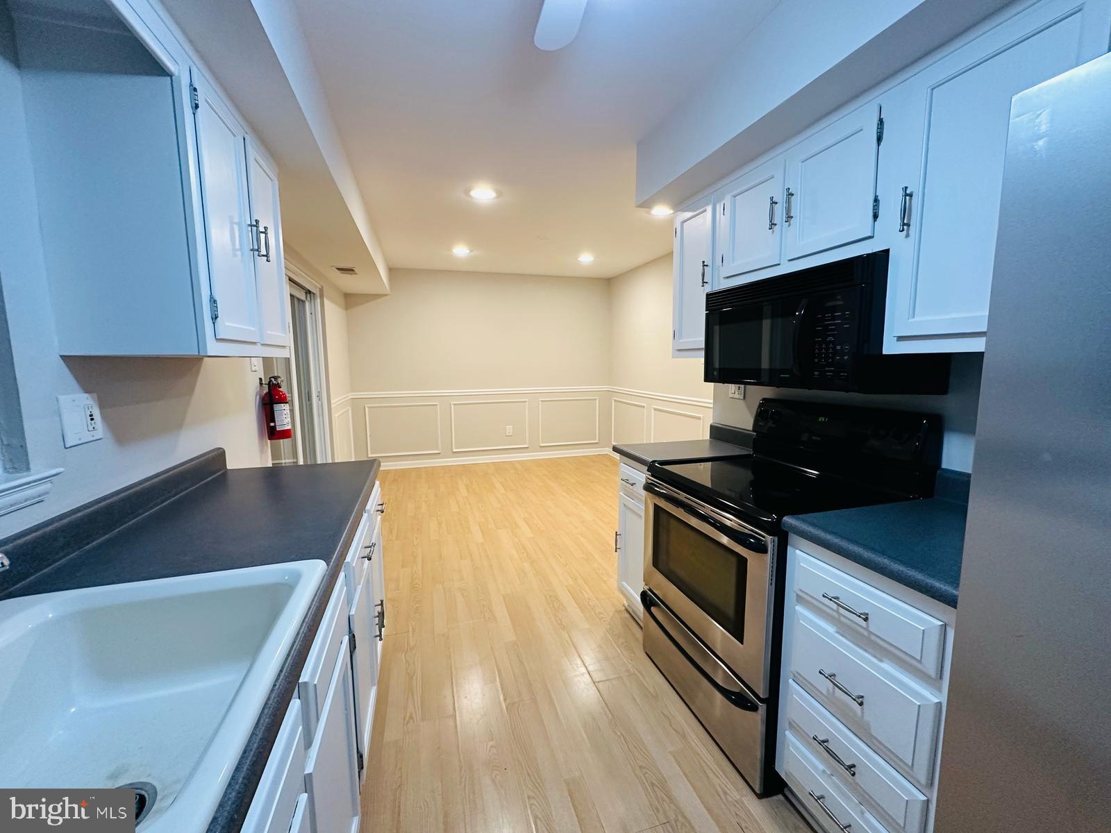 33 Trowbridge Lane Clementon, NJ 08021 - Photo 7 of 20 a kitchen with stainless steel appliances a stove a microwave a sink and cabinets