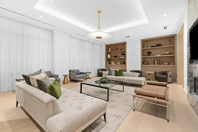 a living room with furniture ceiling fan and a rug