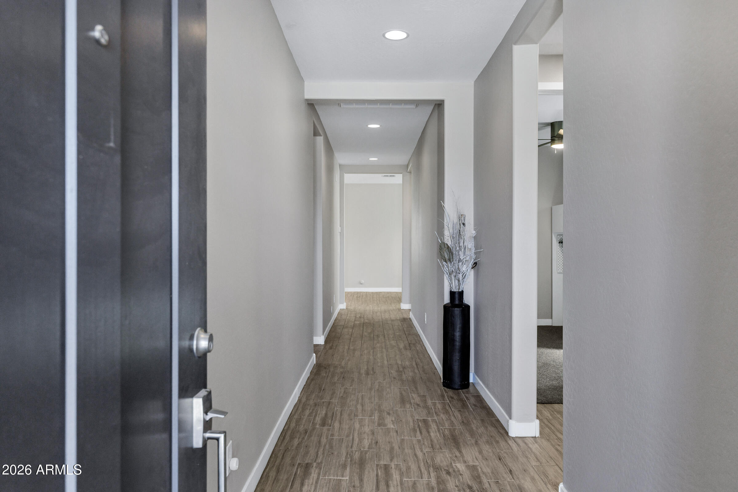 12243 East Sereno Road Gold Canyon, AZ 85118 - Photo 5 of 37 a view of a hallway with wooden floor and staircase