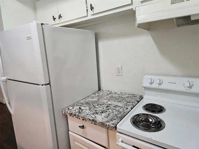 a kitchen with a stove and a refrigerator