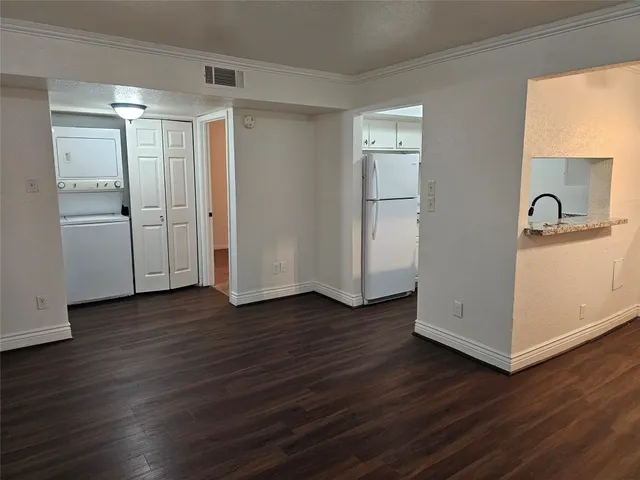a view of kitchen with wooden floor electronic appliances and window